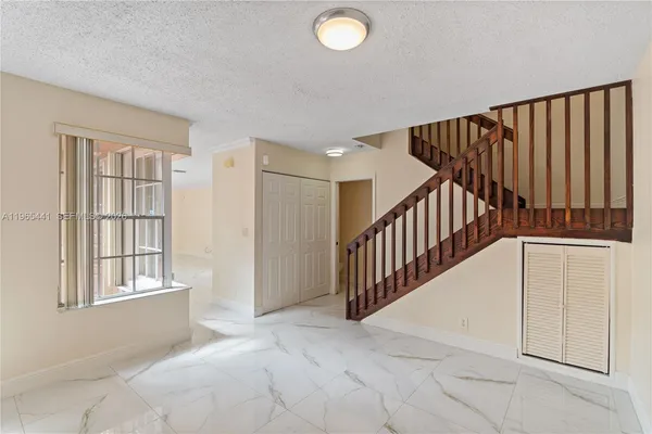 a kitchen with stainless steel appliances granite countertop a refrigerator stove top oven a sink and dishwasher
