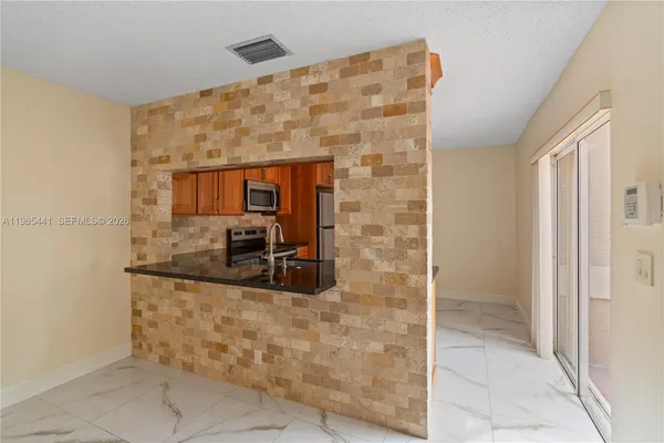 a kitchen with stainless steel appliances granite countertop a sink and cabinets