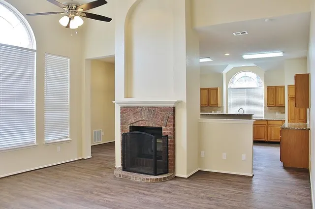 a view of a kitchen with a sink a fireplace and wooden floor