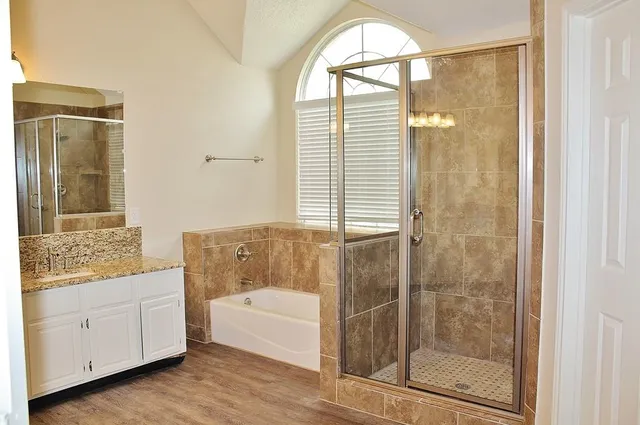 a bathroom with a bathtub and a shower