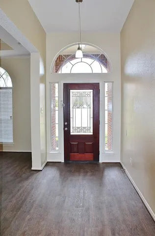 a view of a room with large windows and a chandelier
