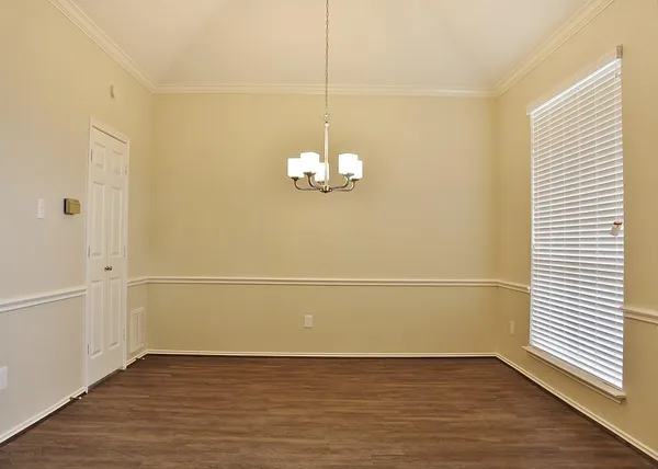 a view of a room with wooden floor and white walls