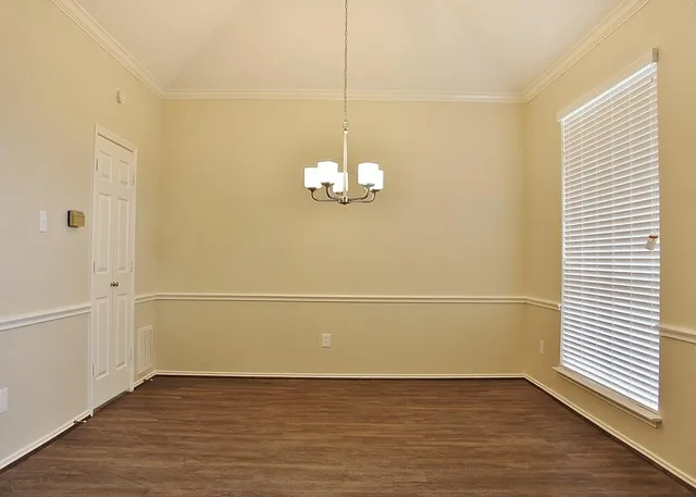 a view of a room with wooden floor and white walls