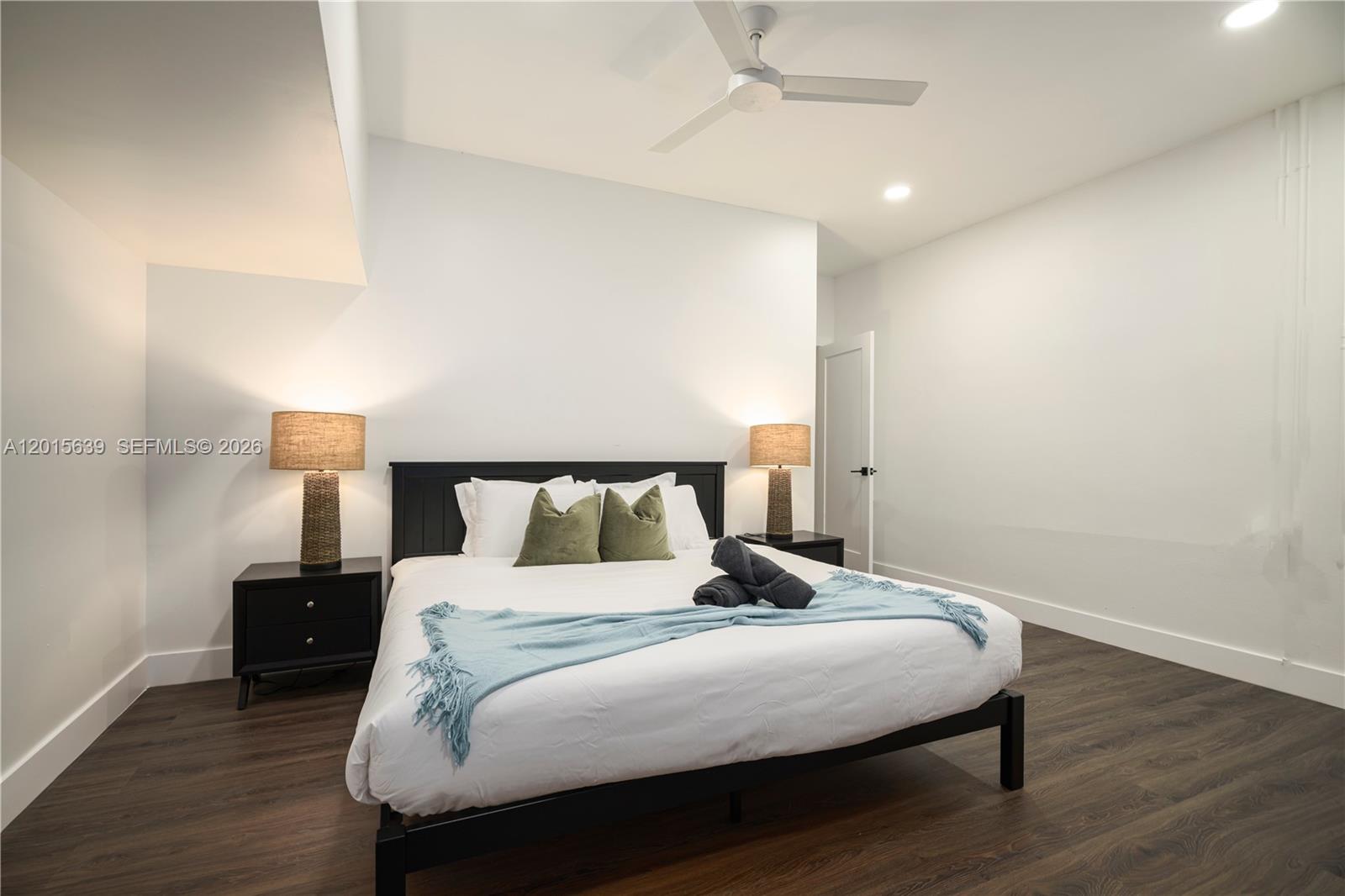 545 Southwest Indianola Street Stuart, FL 34994 - Photo 17 of 64 a bedroom with a bed and a lamp