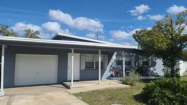 a view of a house with roof deck front of house