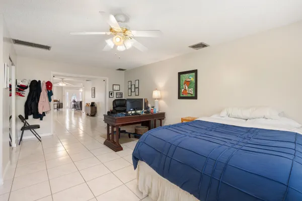 a spacious bedroom with a large bed and a flat screen tv