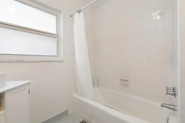 a spacious bedroom with a bed and a flat screen tv