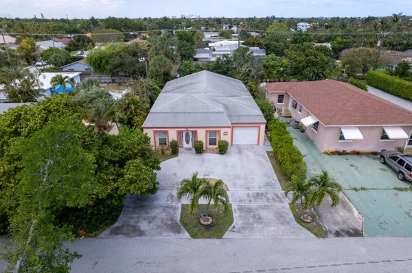 an aerial view of a house with a yard and a fountain