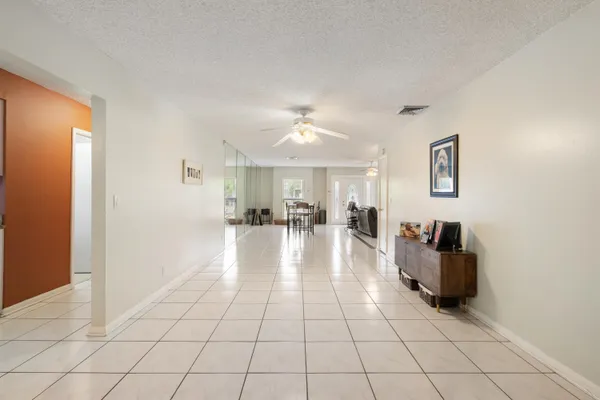 a view of a living room with furniture and a chandelier
