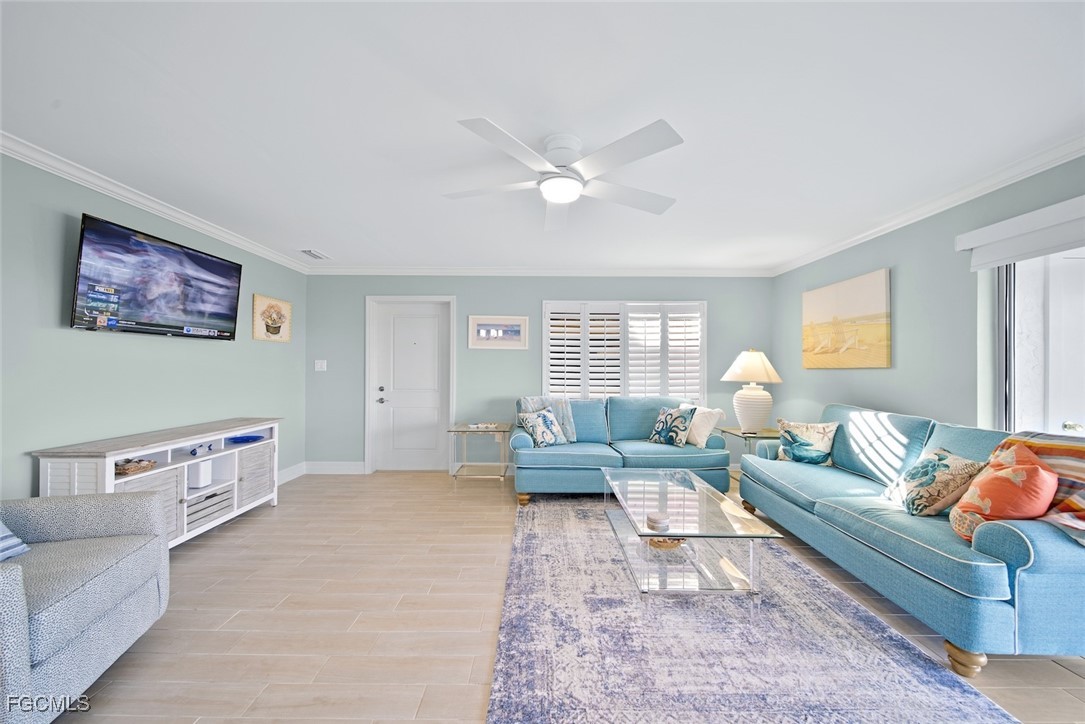 1610 Middle Gulf Drive, Unit D5 Sanibel, FL 33957 - Photo 13 of 47 a living room with furniture and a window