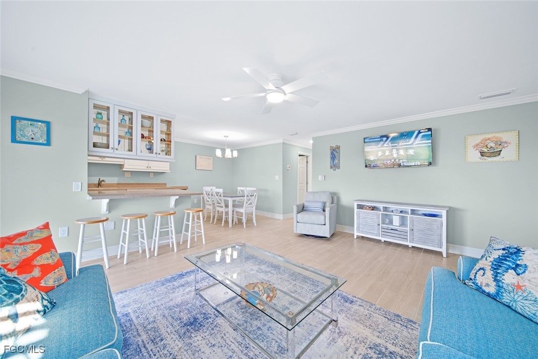 1610 Middle Gulf Drive, Unit D5 Sanibel, FL 33957 - Photo 15 of 47 a living room with furniture and a wooden floor