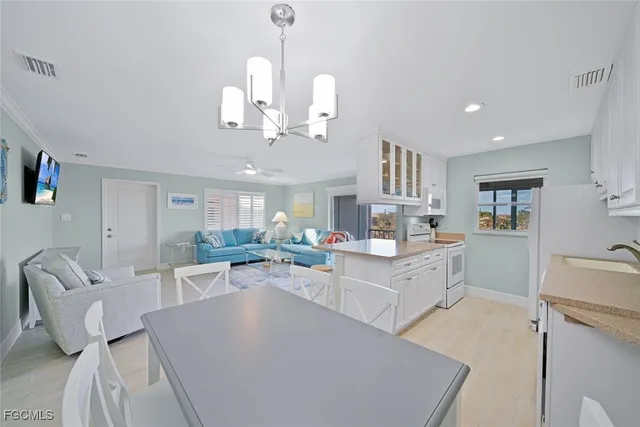 a view of a dining room with furniture wooden floor and a chandelier