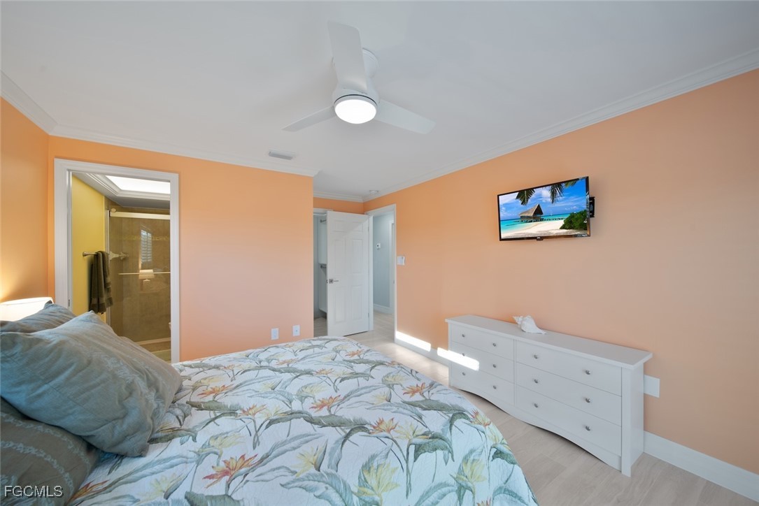 1610 Middle Gulf Drive, Unit D5 Sanibel, FL 33957 - Photo 30 of 47 a bedroom with a large bed and a painting on the wall