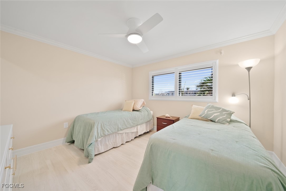 1610 Middle Gulf Drive, Unit D5 Sanibel, FL 33957 - Photo 33 of 47 a bedroom with two beds and a night stand