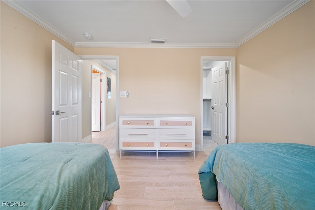 1610 Middle Gulf Drive, Unit D5 Sanibel, FL 33957 - Photo 34 of 47 a bedroom with a bed and a walk in closet