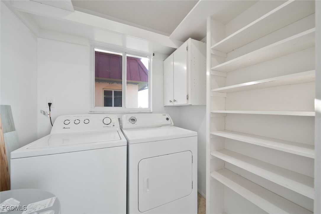 1610 Middle Gulf Drive, Unit D5 Sanibel, FL 33957 - Photo 36 of 47 a utility room with dryer and washer