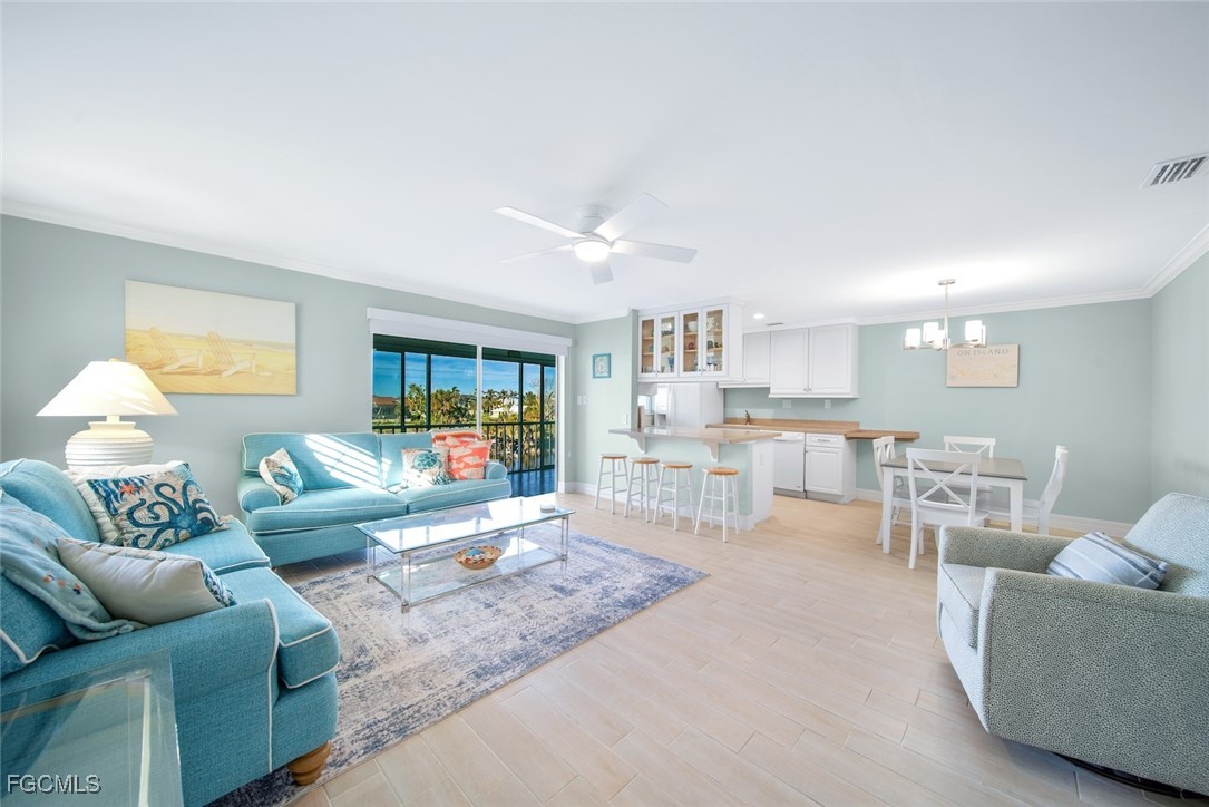 1610 Middle Gulf Drive, Unit D5 Sanibel, FL 33957 - Photo 4 of 47 a living room with furniture and a large window