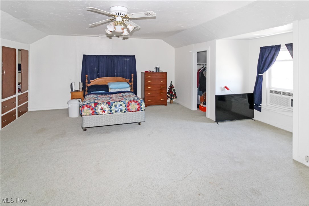 1120 Gypsum Road Gypsum, OH 43433 - Photo 4 of 20 Bedroom with vaulted ceiling, carpet flooring, a ceiling fan, and a closet