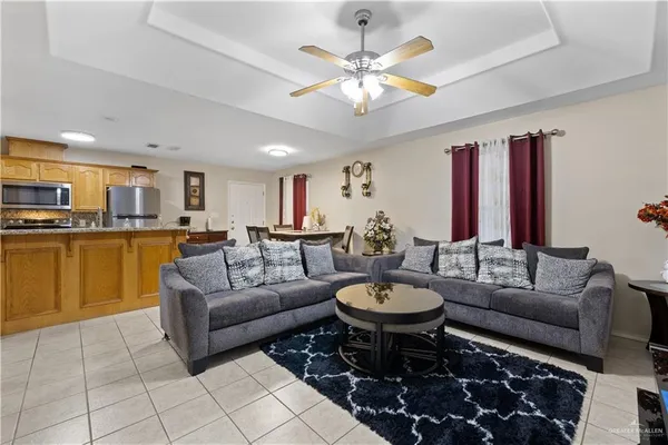 a living room with furniture and view of kitchen
