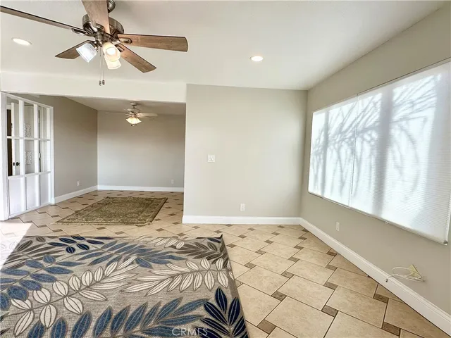 a bedroom with a bed and a chandelier fan