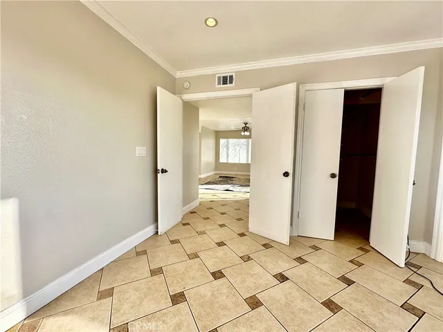 a view of a hallway with wooden floor and a living room