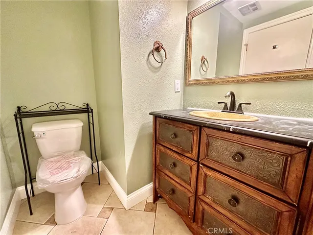 a bathroom with a toilet a sink and a mirror
