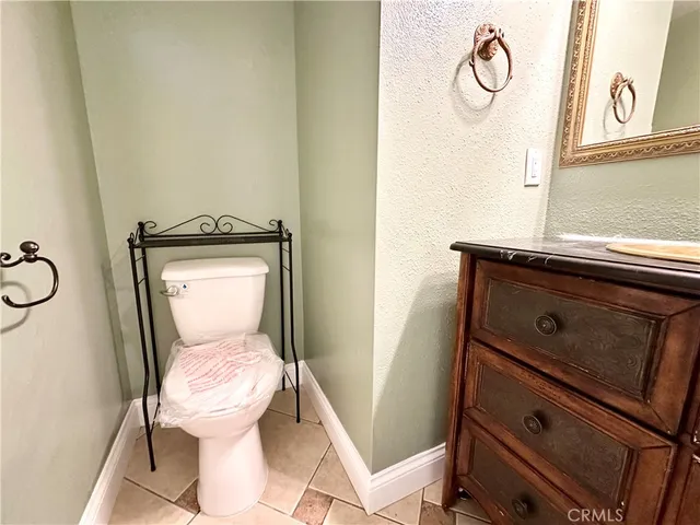 a white toilet sitting next to a bathroom sink