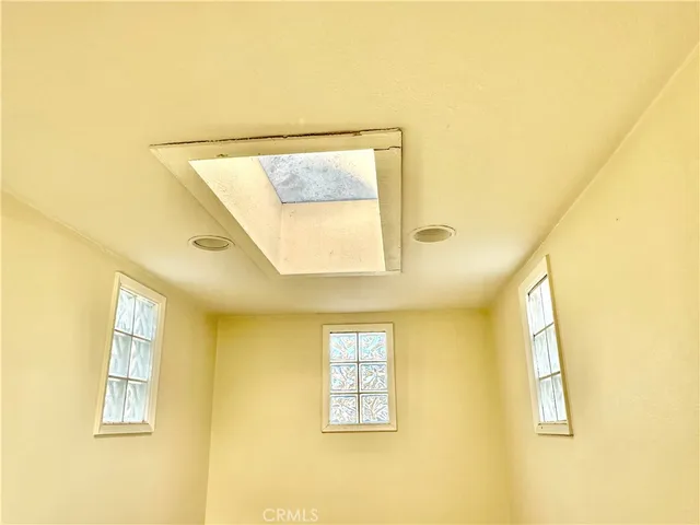 a bathroom with a window and a mirror