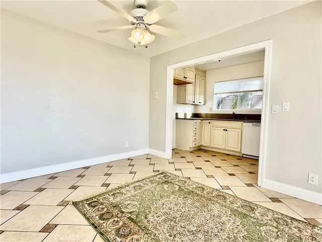 a view of a kitchen with wooden floor and a refrigerator