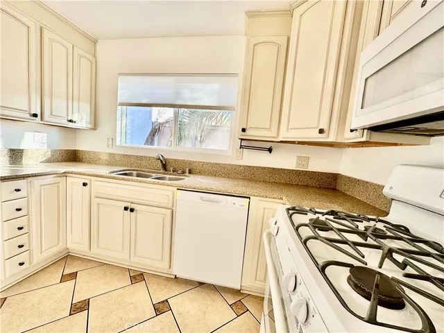a kitchen with stainless steel appliances a stove a sink and a cabinets