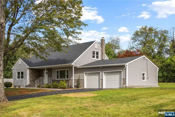 a front view of a house with swimming pool and porch with furniture