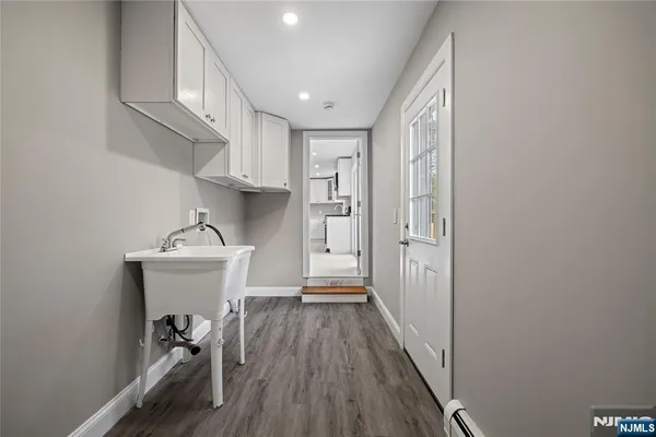 a view of hallway with wooden floor and staircase