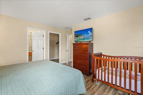 a bedroom with a bed and a flat screen tv
