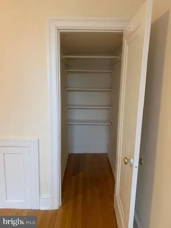 a view of walk in closet with empty racks