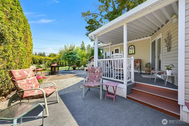 a view of a patio with a table and chairs and potted plants