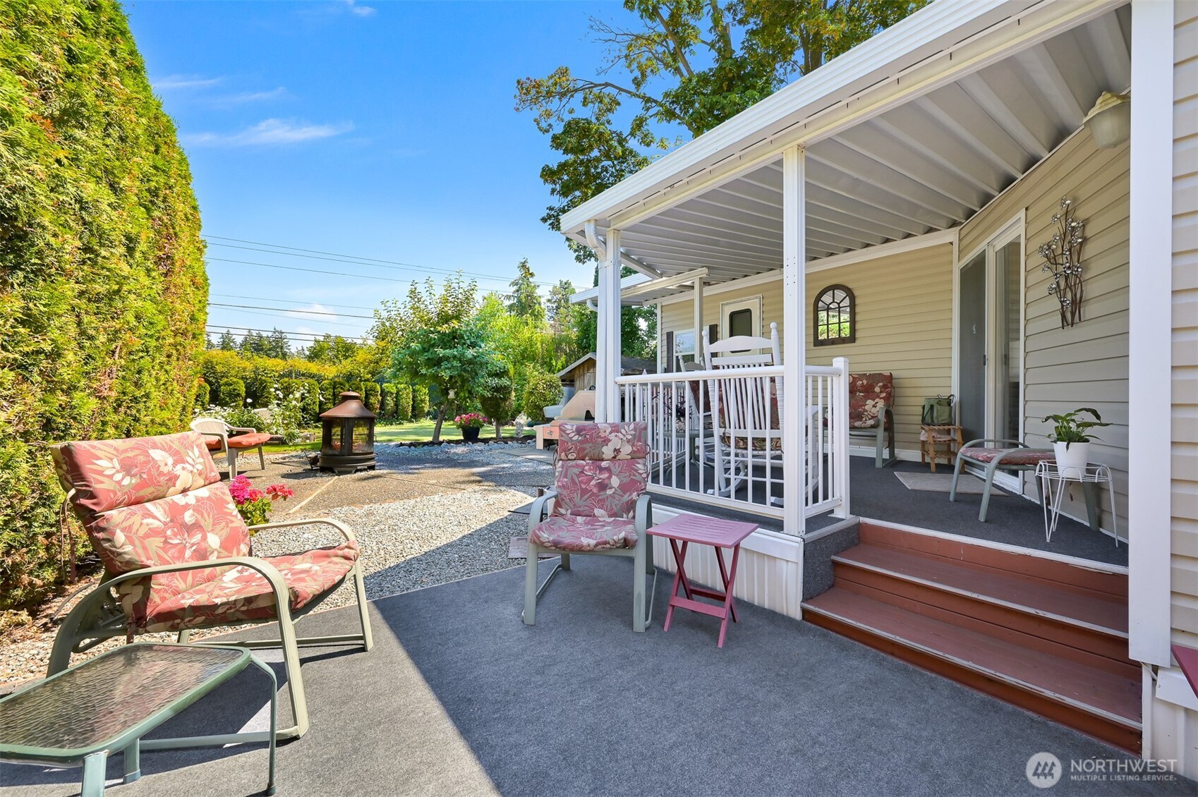 a view of a patio with a table and chairs and potted plants