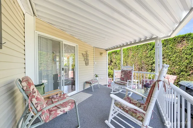 a living room with furniture and floor to ceiling windows