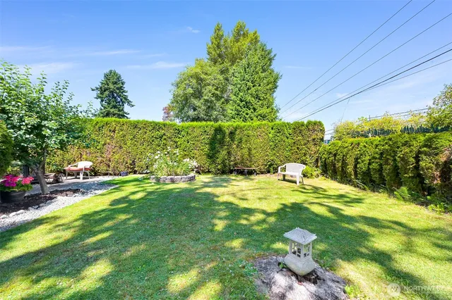 a view of yard with swimming pool and green space