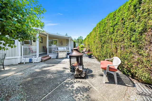 a view of a chairs and tables in the back yard of the house