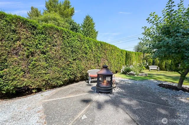 a view of backyard with seating area and green space