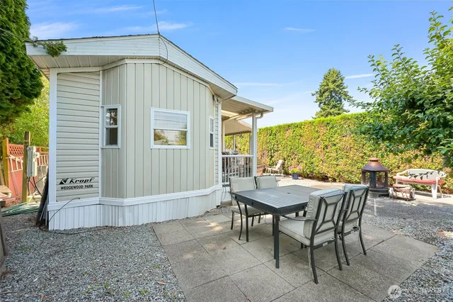 a backyard of a house with table and chairs