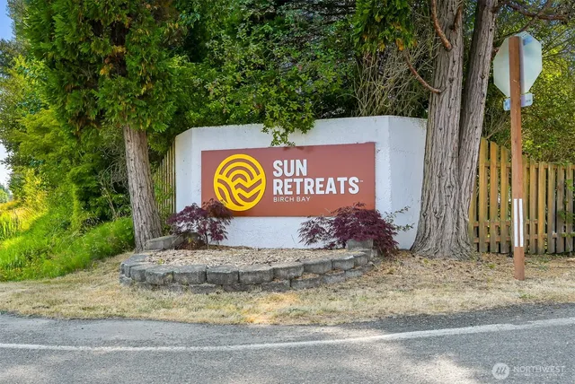 a sign broad on a pole on a street