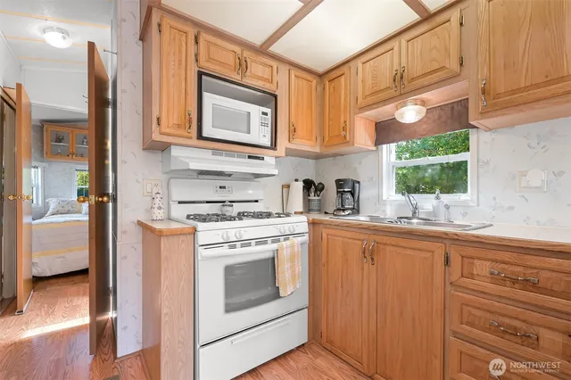 a kitchen with stainless steel appliances granite countertop a stove and a sink
