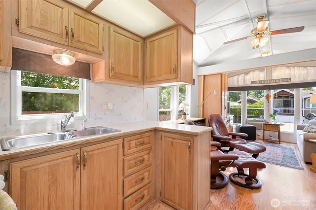 a kitchen with sink refrigerator and window