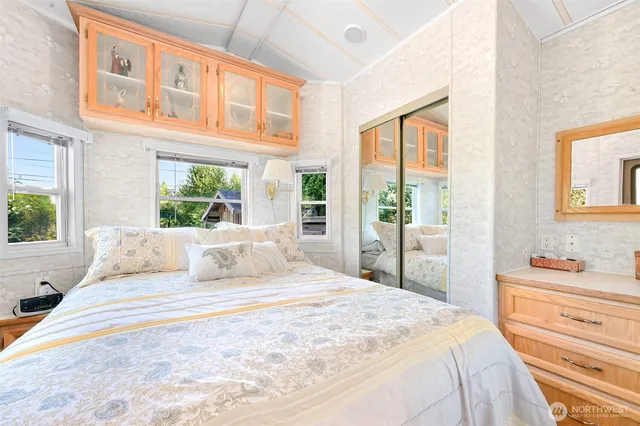 a bedroom with a large bed and a large window