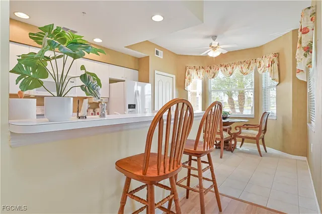 a view of a dining room with furniture a chandelier and a window