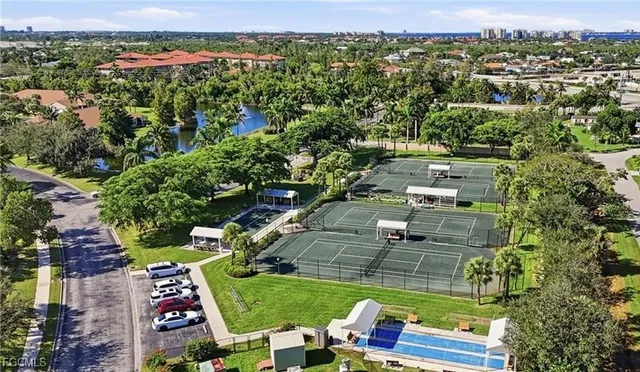 an aerial view of residential houses with outdoor space and trees