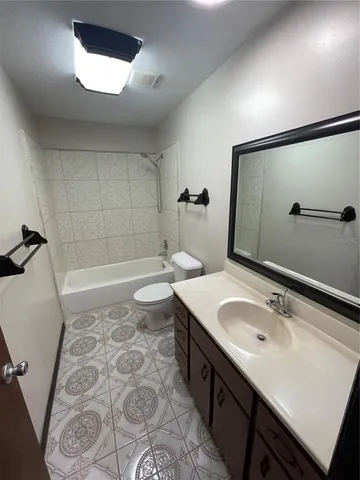 a view of a porch with furniture and floor to ceiling window