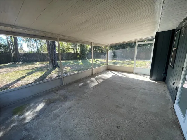 a view of a house with backyard and tree