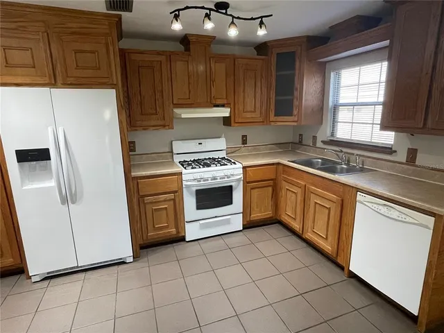 a kitchen with a stove a sink and a refrigerator